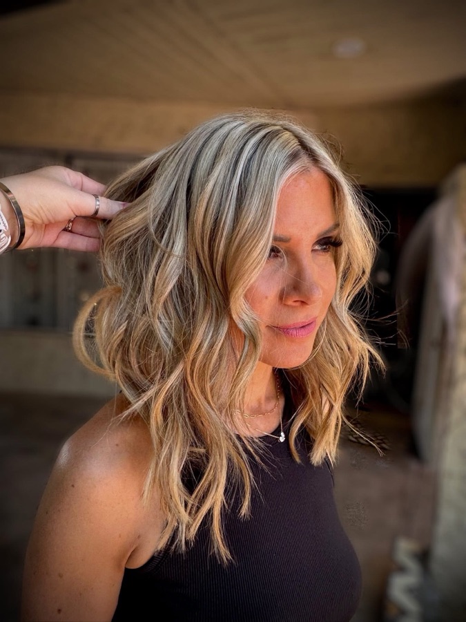 Guest smiling with soft blonde beach waves