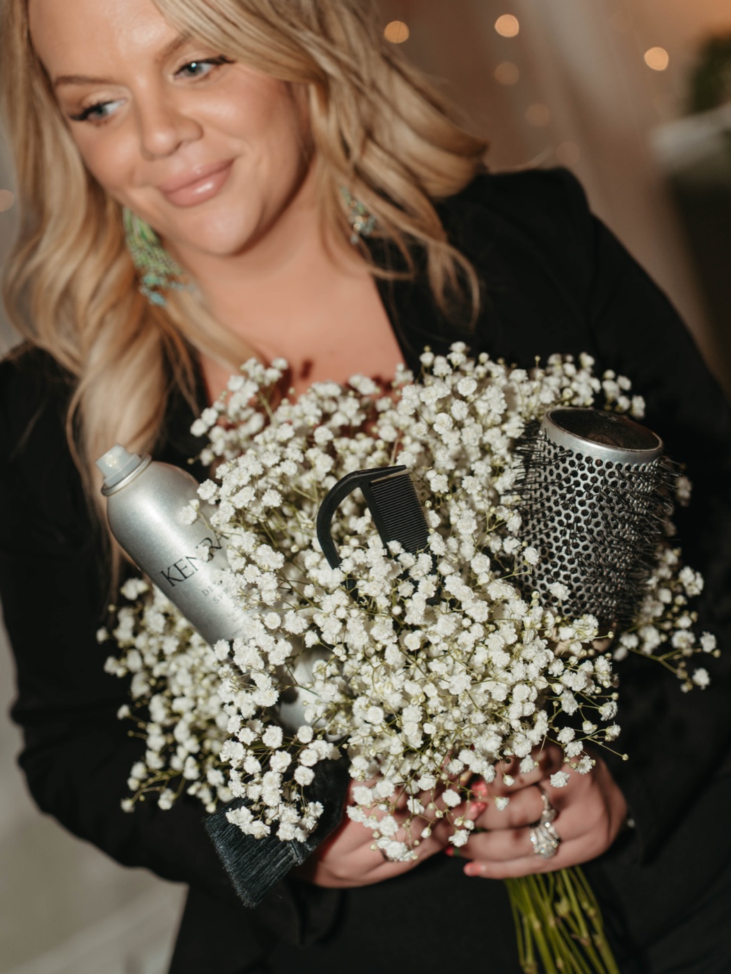 Kate holding a bouquet of baby's breath and styling tools